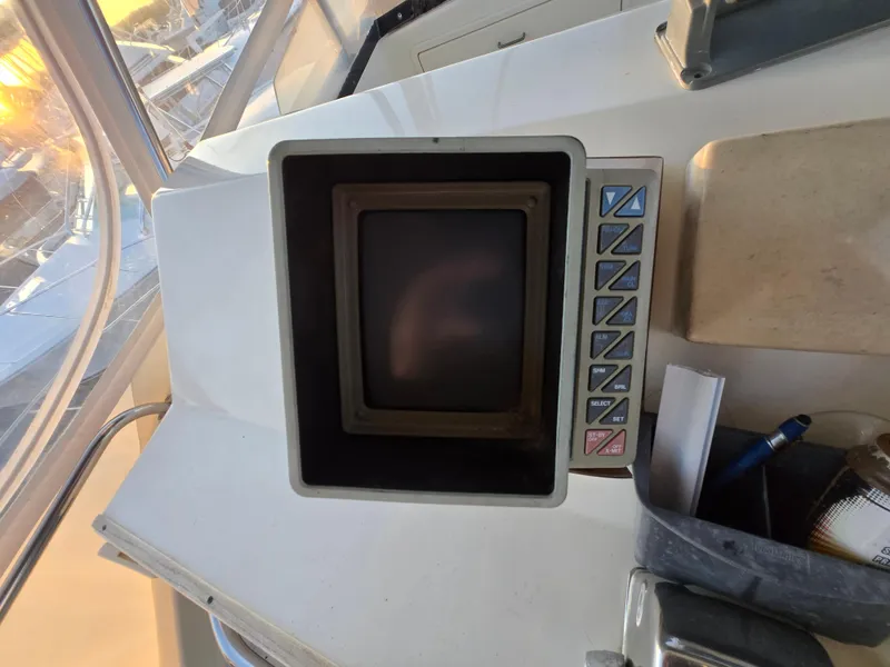 Slide: The Image of Control panel of a 1988 Ocean 35 Super Sport boat with buttons and screen. - 21