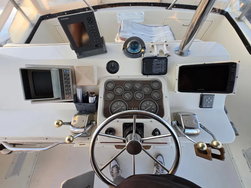 Slide: The Image of Control panel of a 1988 Ocean 35 Super Sport boat with navigation instruments. - 24