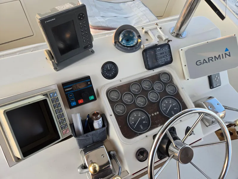 Slide: The Image of Control panel of a 1988 Ocean 35 Super Sport boat with navigation instruments. - 27