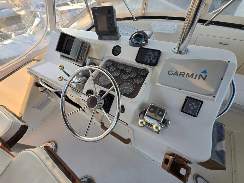 Slide: The Image of 1988 Ocean 35 Super Sport boat helm with Garmin navigation system and steering wheel. - 3