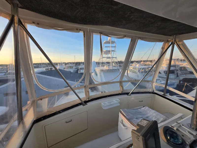 Slide: The Image of 1988 Ocean 35 Super Sport boat interior view at marina during sunset. - 31