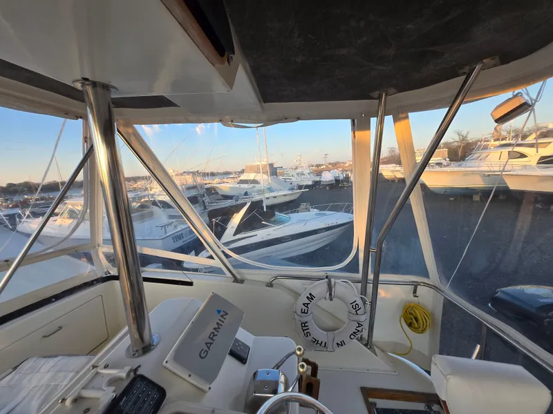 Slide: The Image of Interior view of a 1988 Ocean 35 Super Sport yacht with marina in background. - 32