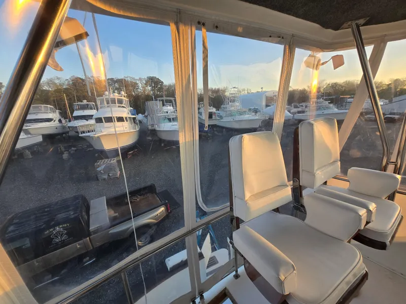 Slide: The Image of Interior view of 1988 Ocean 35 Super Sport boat with marina backdrop at sunset. - 33