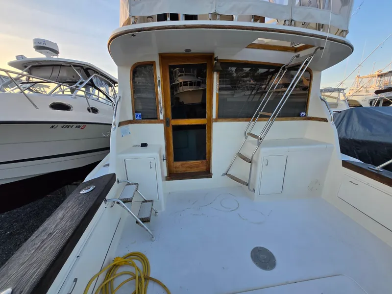 Slide: The Image of 1988 Ocean 35 Super Sport boat deck with ladder and storage compartments. - 36