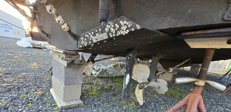 Slide: The Image of 1988 Ocean 35 Super Sport boat hull with barnacles and propellers on dry dock. - 39