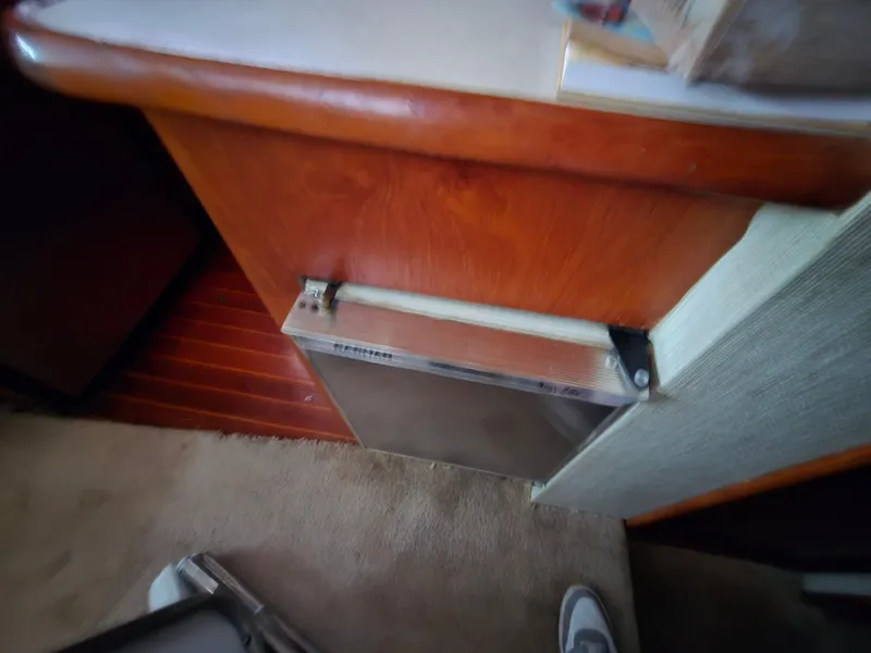 Slide: The Image of 1988 Ocean 35 Super Sport interior with wooden cabinetry and carpeted flooring. - 42