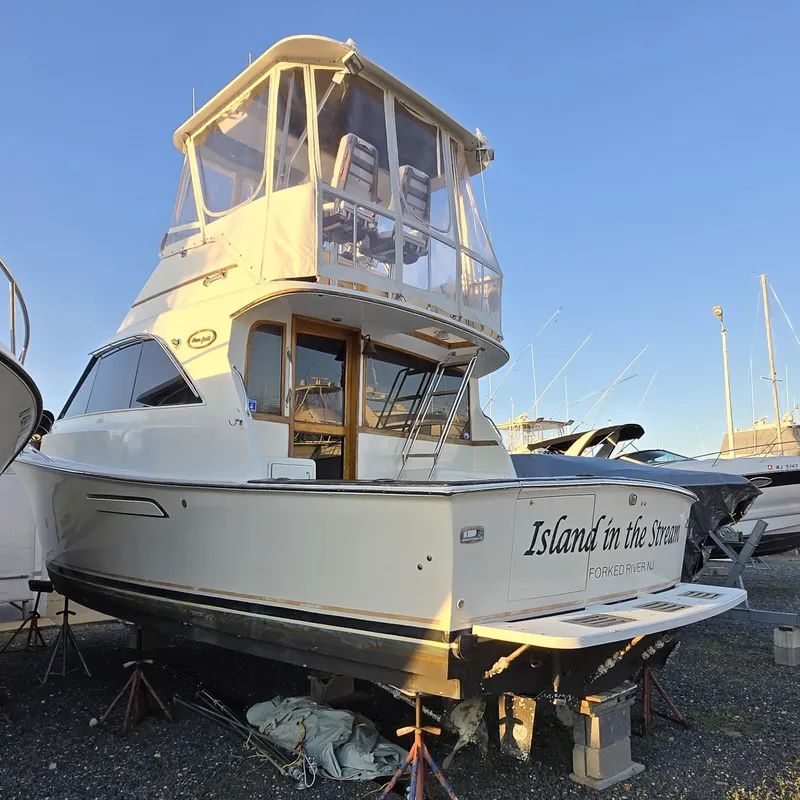 Slide: The Image of 1988 Ocean 35 Super Sport yacht on land, named "Island in the Stream." - 7