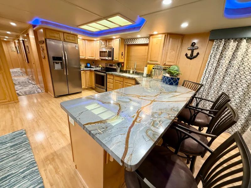 Slide: The Image of Luxurious kitchen interior of 2001 Sumerset 18x104 houseboat with modern appliances and elegant design. - 10