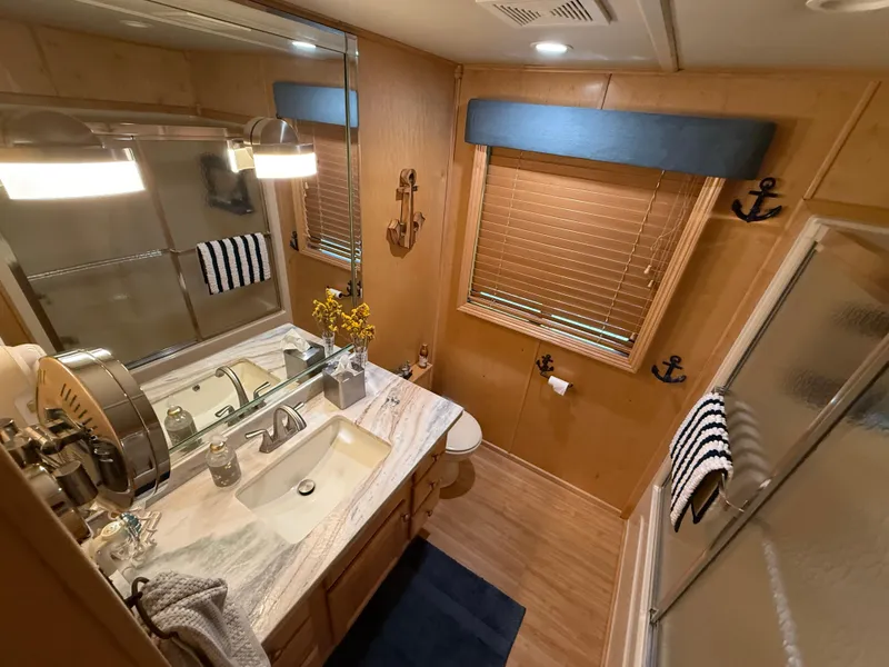 Slide: The Image of Bathroom in 2001 Sumerset 18x104 houseboat with nautical decor and modern fixtures. - 15