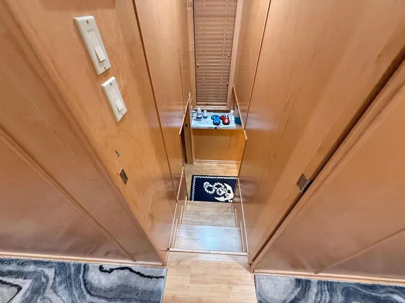 Slide: The Image of Interior view of 2001 Sumerset 18x104 houseboat hallway with wooden walls and steps. - 18