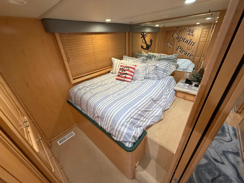 Slide: The Image of Cozy bedroom in 2001 Sumerset 18x104 houseboat with nautical decor and striped bedding. - 21