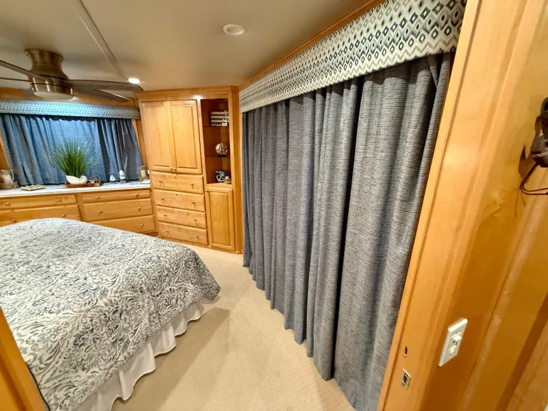 Slide: The Image of Luxurious bedroom interior in 2001 Sumerset 18x104 houseboat with elegant wood cabinetry and patterned bedding. - 26