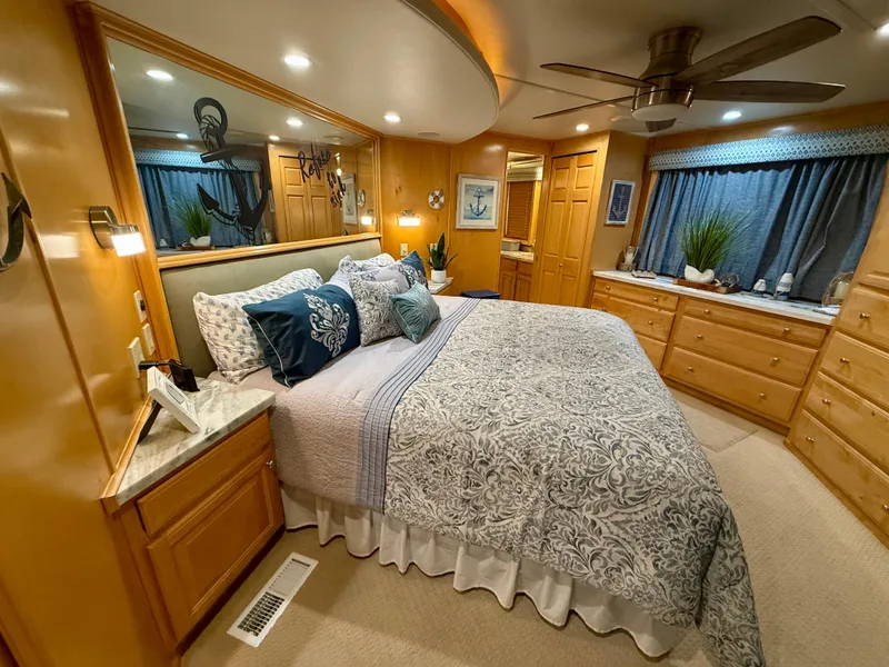Slide: The Image of Luxurious bedroom in 2001 Sumerset 18x104 houseboat with elegant decor and ample storage. - 27
