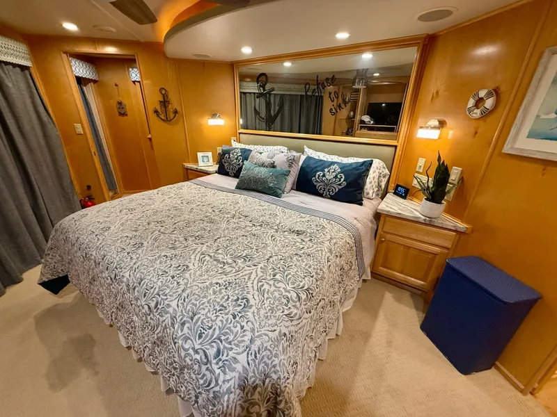 Slide: The Image of Luxurious bedroom in 2001 Sumerset 18x104 houseboat with elegant bedding and nautical decor. - 28