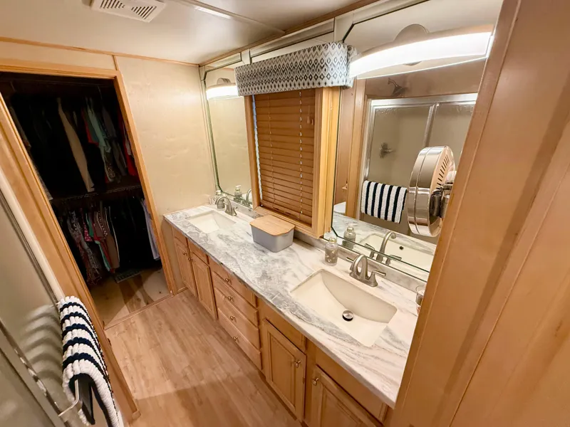 Slide: The Image of Luxurious bathroom in 2001 Sumerset 18x104 houseboat with dual sinks and marble countertop. - 29
