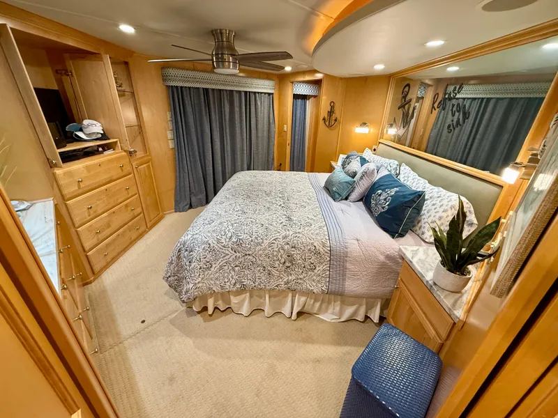 Slide: The Image of Luxurious bedroom in a 2001 Sumerset 18x104 houseboat with elegant decor and cozy bedding. - 34