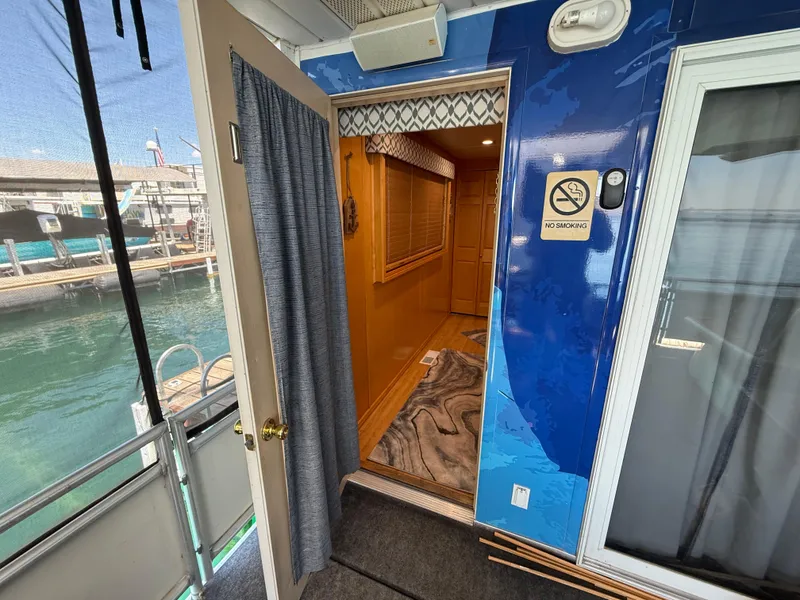 Slide: The Image of Interior view of a 2001 Sumerset 18x104 houseboat with open door and "No Smoking" sign. - 38