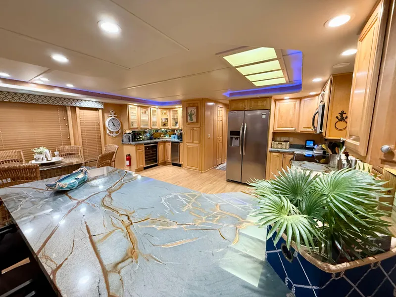 Slide: The Image of Luxurious kitchen interior of 2001 Sumerset 18x104 houseboat with modern appliances and elegant decor. - 4