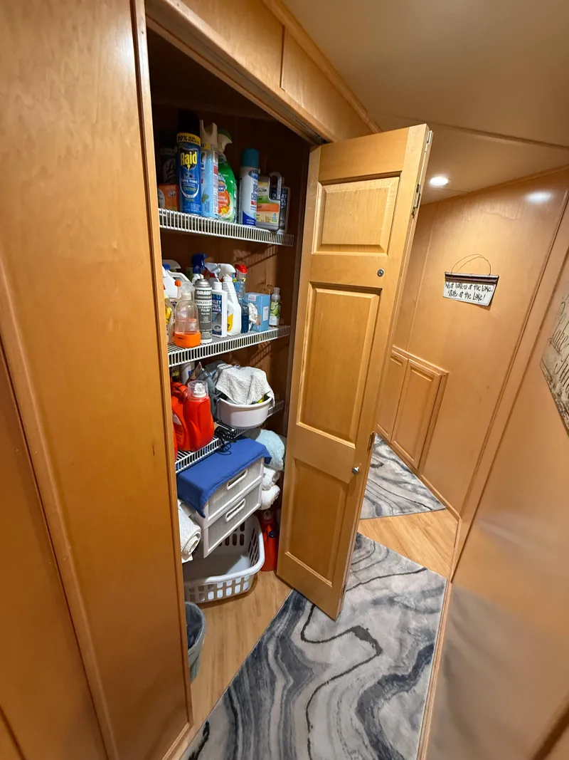 Slide: The Image of Storage closet in a 2001 Sumerset 18x104 houseboat, stocked with cleaning supplies and household items. - 40