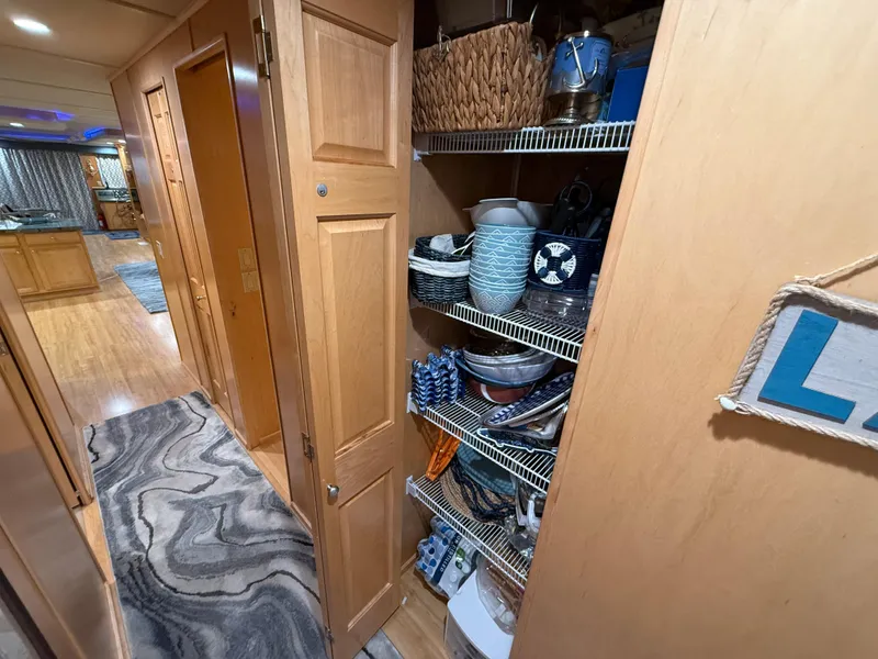 Slide: The Image of Pantry with organized shelves in a 2001 Sumerset 18x104 houseboat interior. - 42