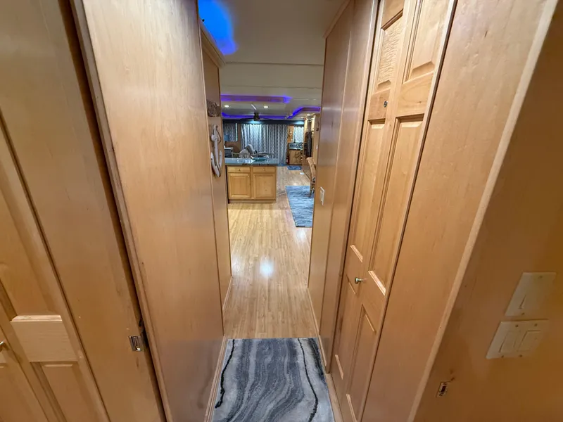 Slide: The Image of Hallway view inside 2001 Sumerset 18x104 houseboat, featuring wooden interior and modern lighting. - 43