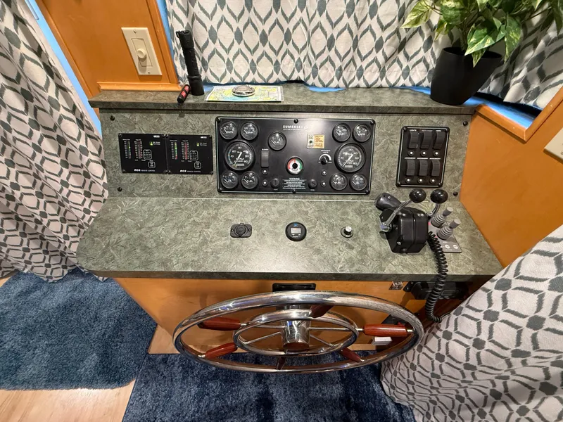 Slide: The Image of Control panel of a 2001 Sumerset 18x104 houseboat with steering wheel and gauges. - 46
