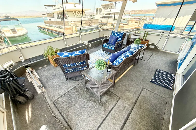 Slide: The Image of Houseboat interior with wicker furniture, blue cushions, and lake view; Sumerset 18x104, 2001 model. - 69