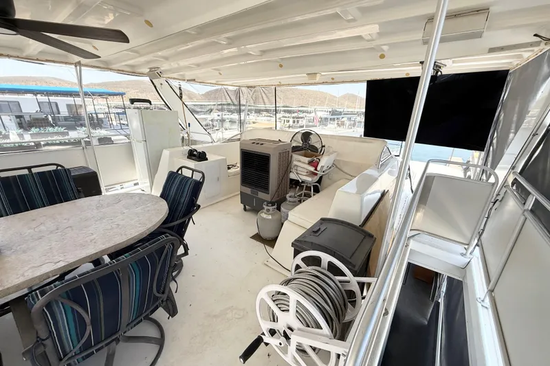 Slide: The Image of 2001 Sumerset 18x104 houseboat interior with seating, dining table, and helm station. - 72