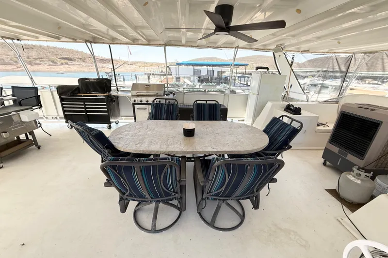 Slide: The Image of Outdoor dining area on 2001 Sumerset 18x104 houseboat with table, chairs, and grill. - 73