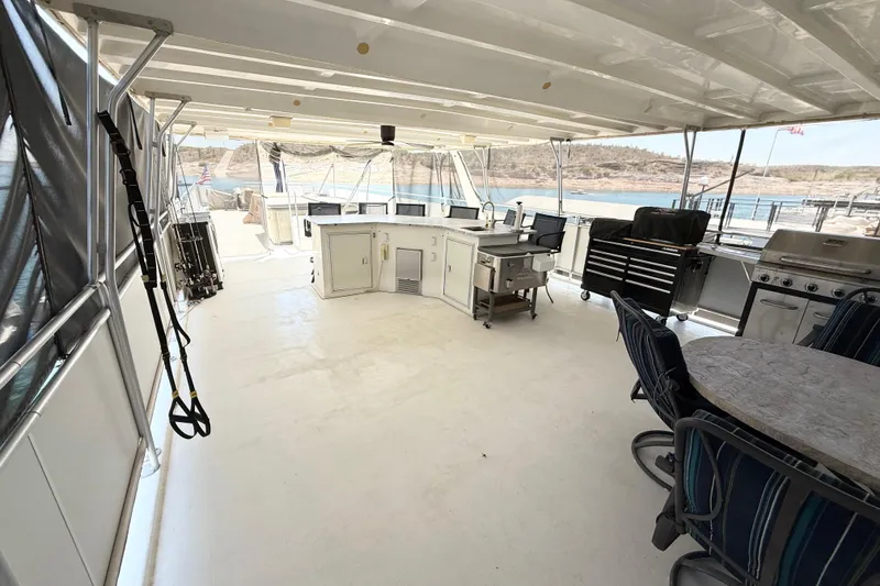 Slide: The Image of Covered deck of a 2001 Sumerset 18x104 houseboat with outdoor kitchen and seating. - 74