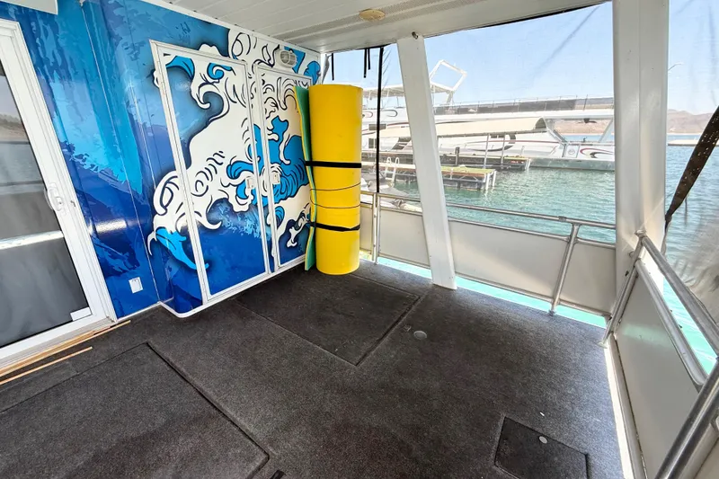 Slide: The Image of Houseboat interior with wave mural, yellow buoy, and lake view. Sumerset 18x104, 2001 model. - 78