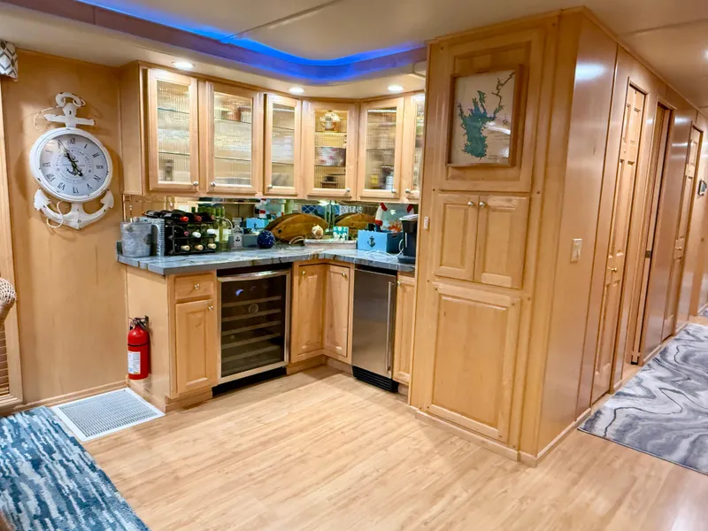Slide: The Image of Luxurious 2001 Sumerset 18x104 houseboat interior with elegant wooden cabinetry and modern amenities. - 9