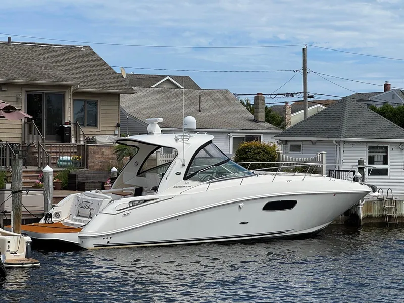 The Image of 2008 Sea Ray 350 Sundancer yacht docked near waterfront homes. - 0