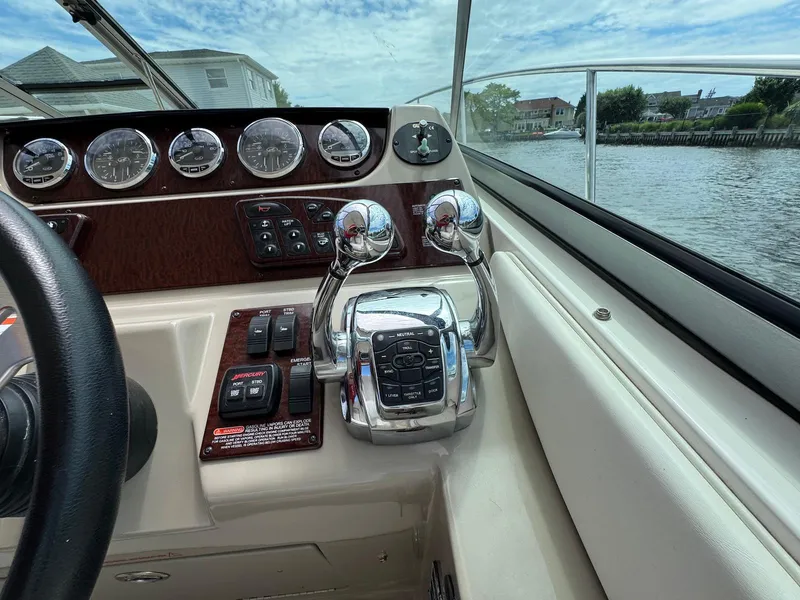 Slide: The Image of Control panel of 2008 Sea Ray 350 Sundancer boat with gauges and throttle levers. - 10