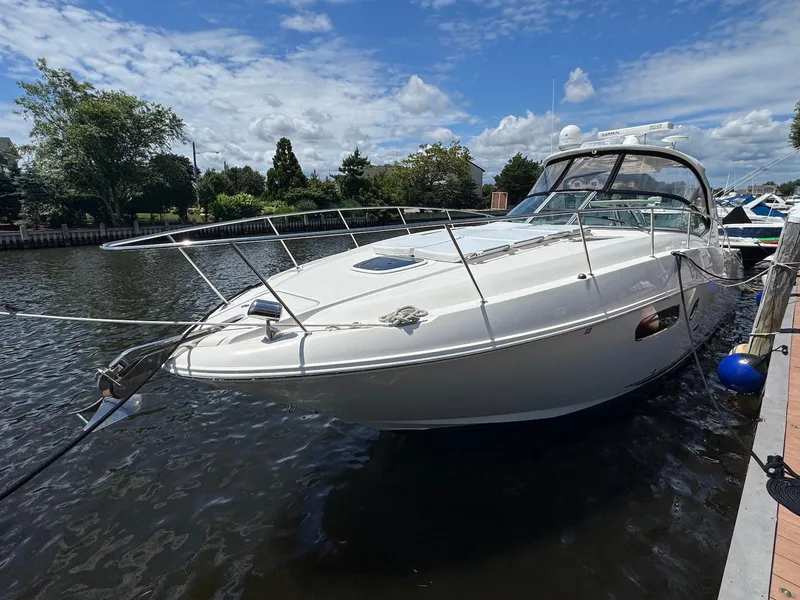 Slide: The Image of 2008 Sea Ray 350 Sundancer yacht docked on a sunny day, surrounded by water and greenery. - 2