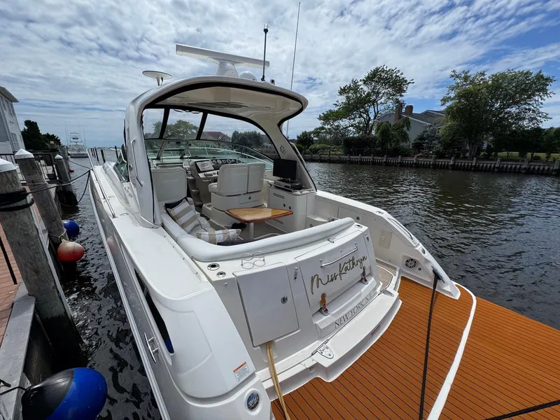 Slide: The Image of 2008 Sea Ray 350 Sundancer docked, featuring spacious deck and luxurious seating. - 22