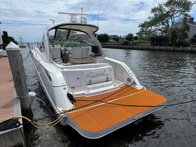 Slide: The Image of 2008 Sea Ray 350 Sundancer yacht docked by a wooden pier. - 23