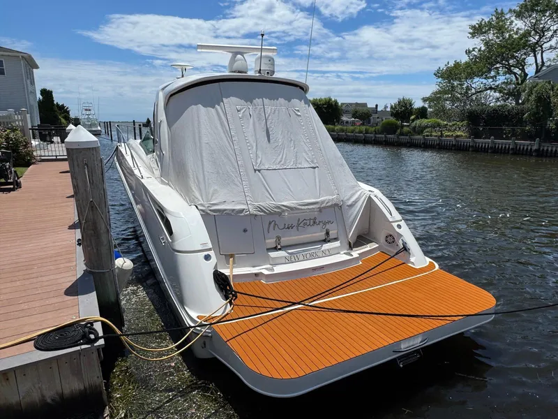 Slide: The Image of 2008 Sea Ray 350 Sundancer docked, covered, with wooden deck, under a clear blue sky. - 24