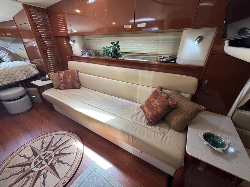 Slide: The Image of Luxurious interior of 2008 Sea Ray 350 Sundancer with beige sofa and decorative pillows. - 26
