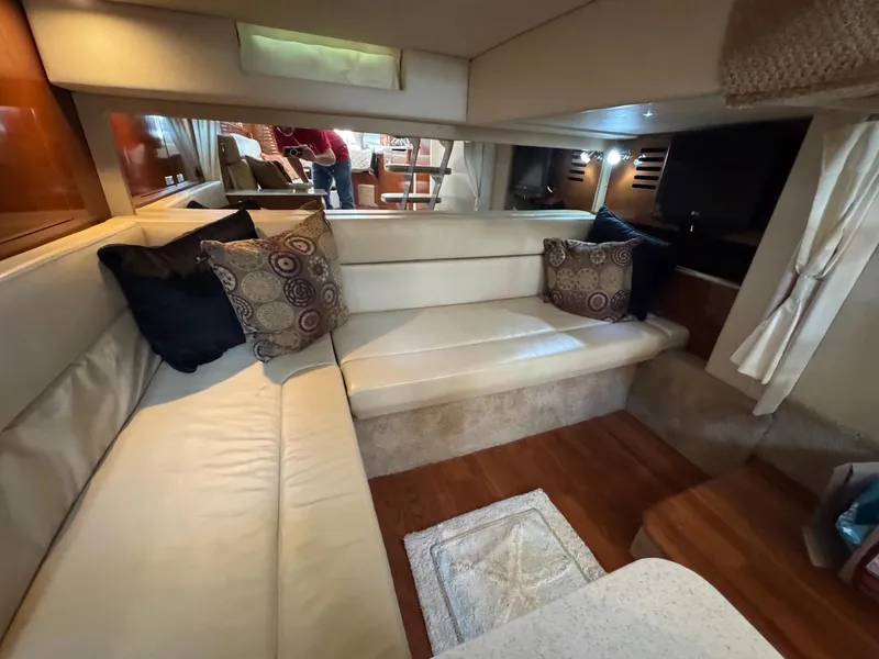 Slide: The Image of Interior of 2008 Sea Ray 350 Sundancer with beige seating and decorative pillows. - 30