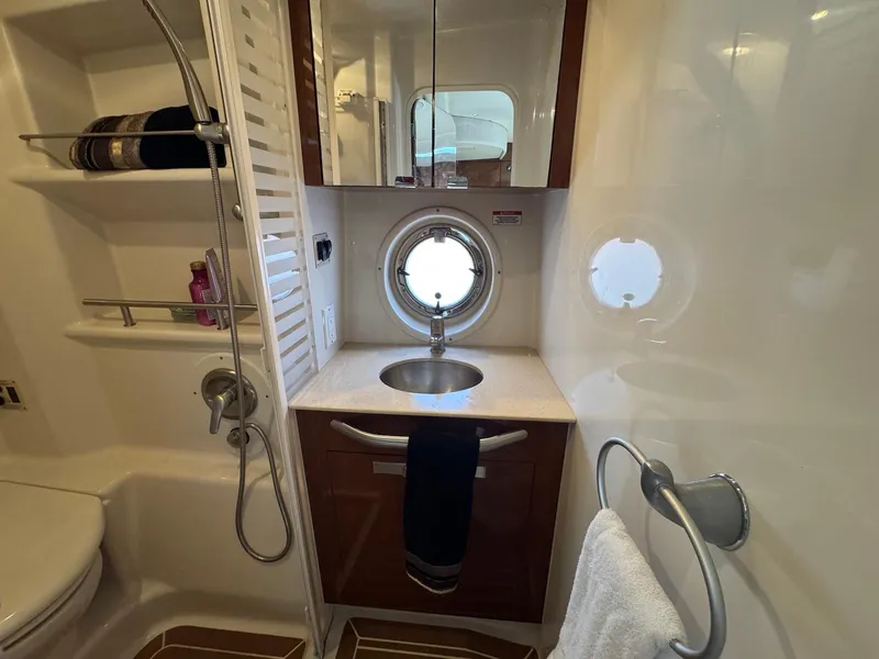 Slide: The Image of Luxurious bathroom in 2008 Sea Ray 350 Sundancer yacht with sink, shower, and porthole window. - 33