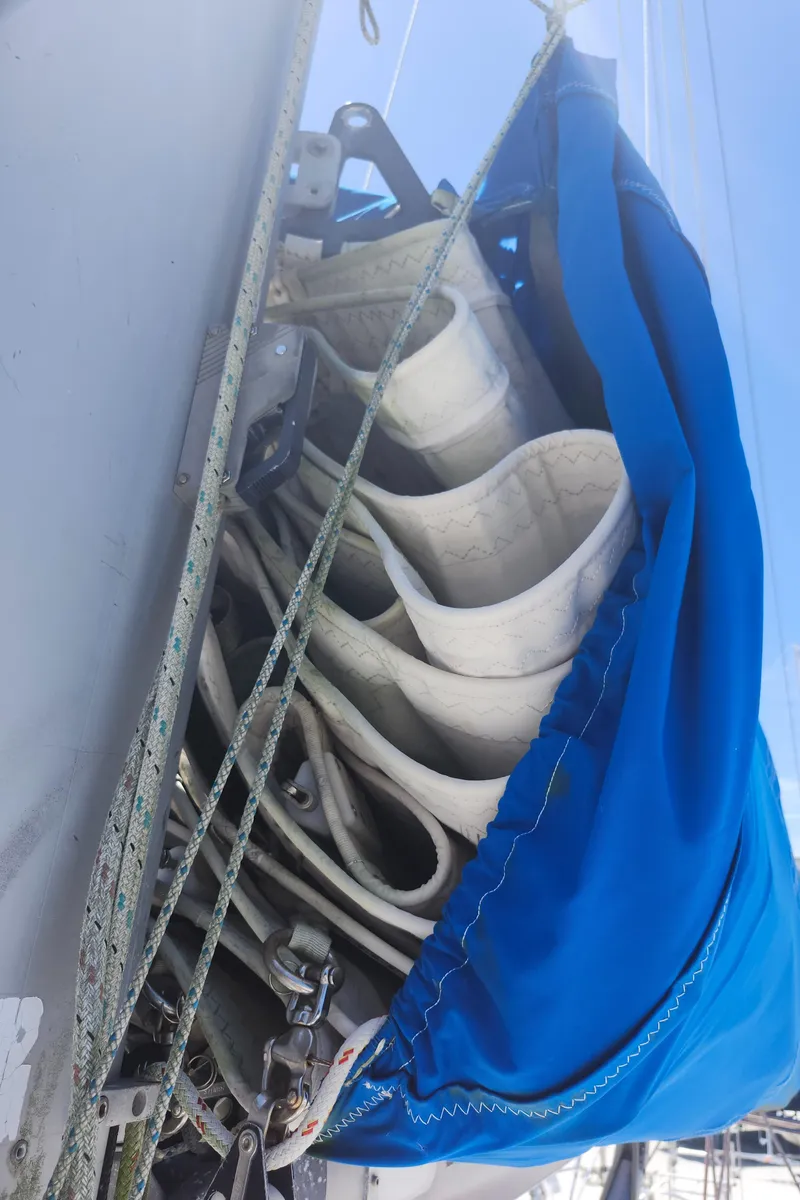 Slide: The Image of Sailboat mast with neatly folded sails and blue cover, Beneteau 50, 2003 model. - 11