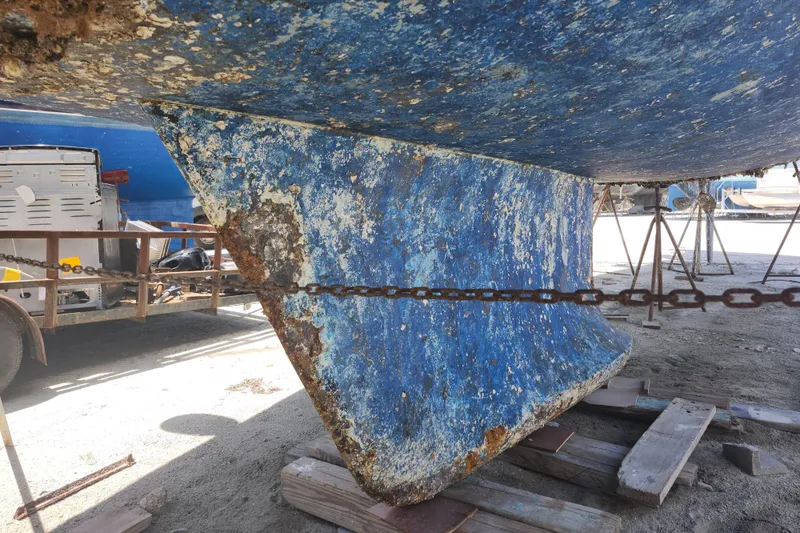 Slide: The Image of Aging hull of a 2003 Beneteau 50 sailboat on dry dock. - 13