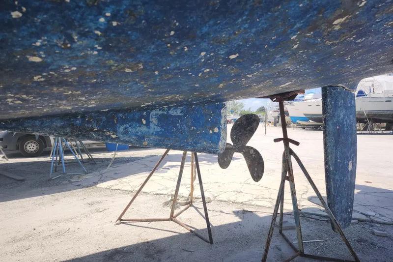 Slide: The Image of Bottom view of a 2003 Beneteau 50 sailboat on stands, showing propeller and keel. - 15