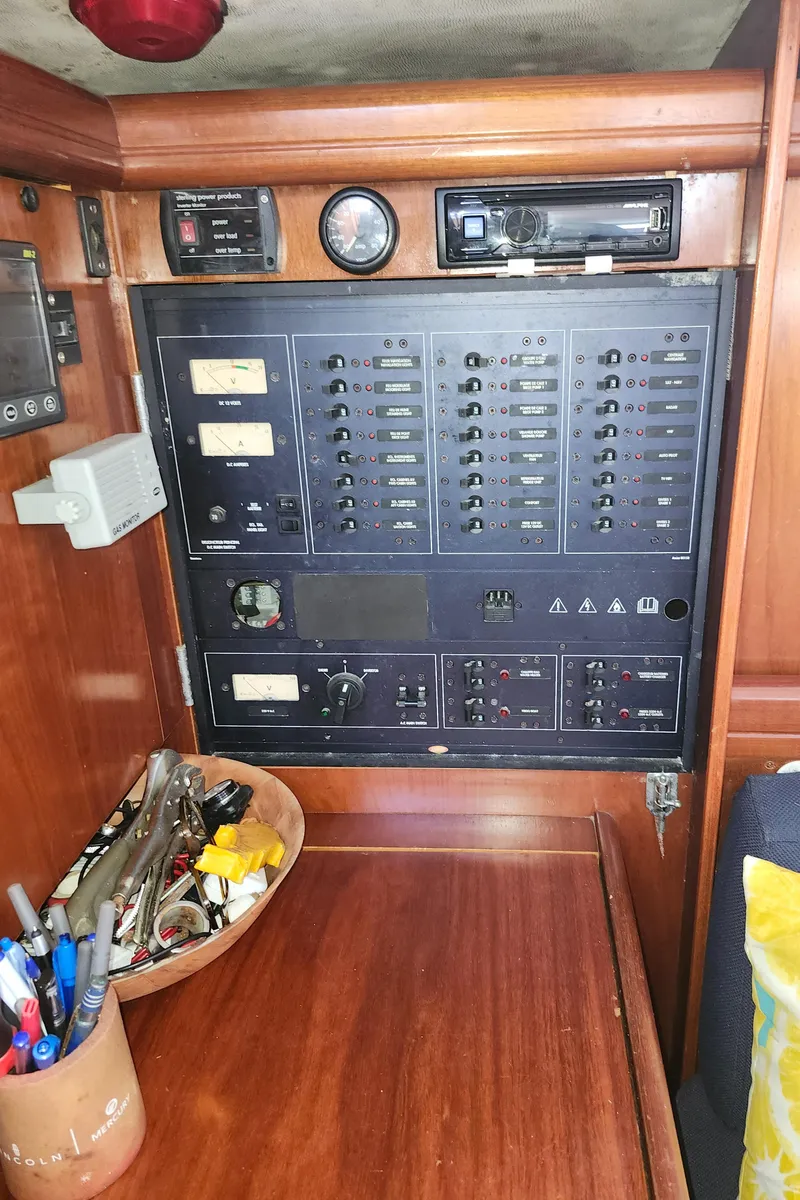 Slide: The Image of Electrical control panel on a 2003 Beneteau 50 yacht, featuring various switches and gauges. - 21
