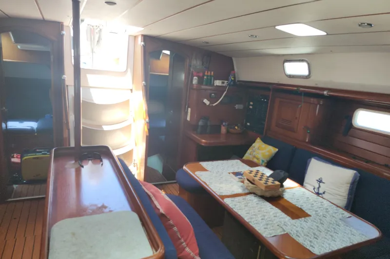 Slide: The Image of Interior of 2003 Beneteau 50 yacht with cozy seating and wooden finishes. - 27