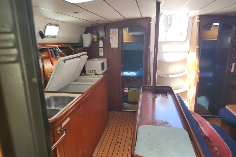 Slide: The Image of Interior of 2003 Beneteau 50 yacht with kitchen and seating area. - 28