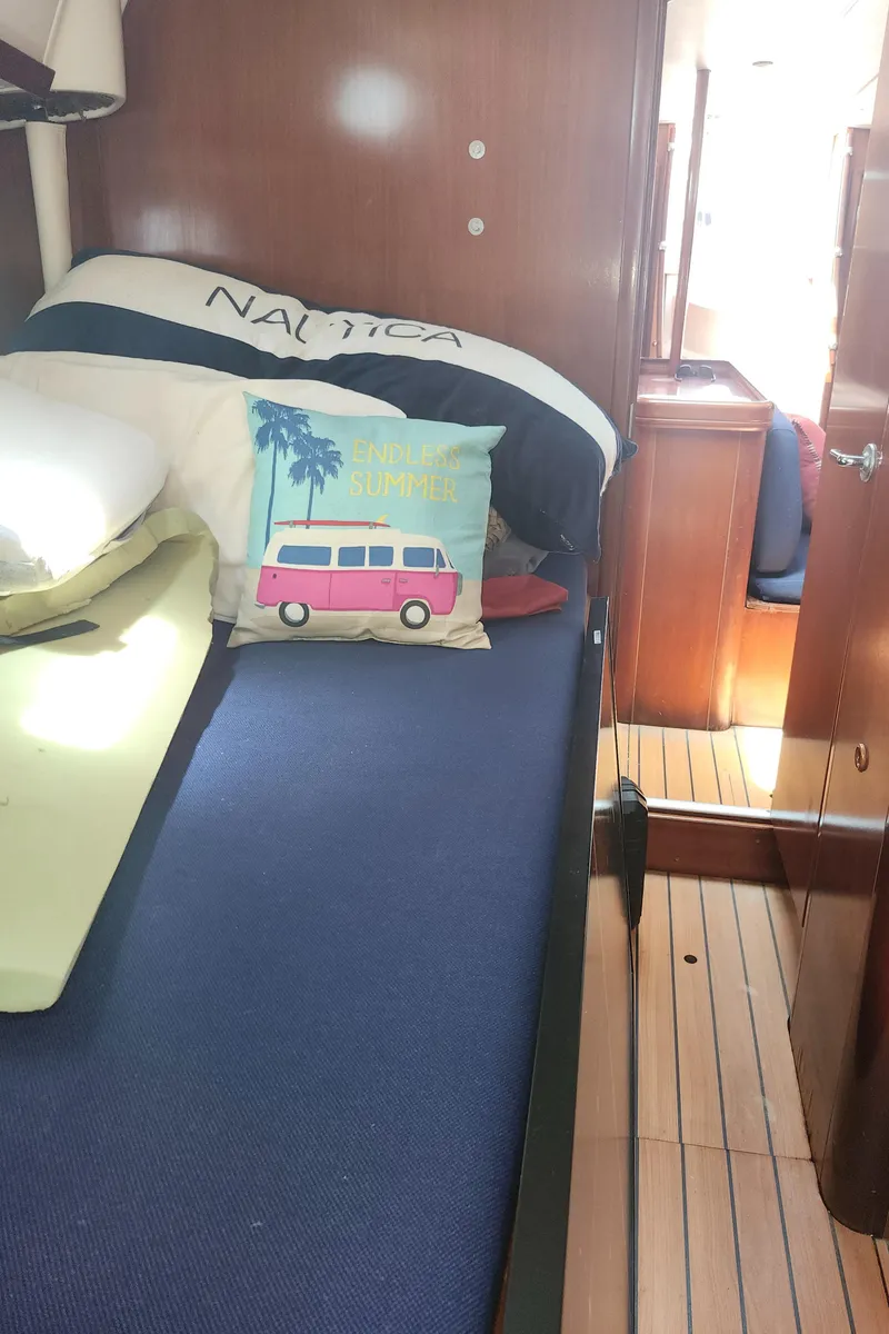 Slide: The Image of Cozy cabin interior of 2003 Beneteau 50 sailboat with nautical-themed decor. - 32