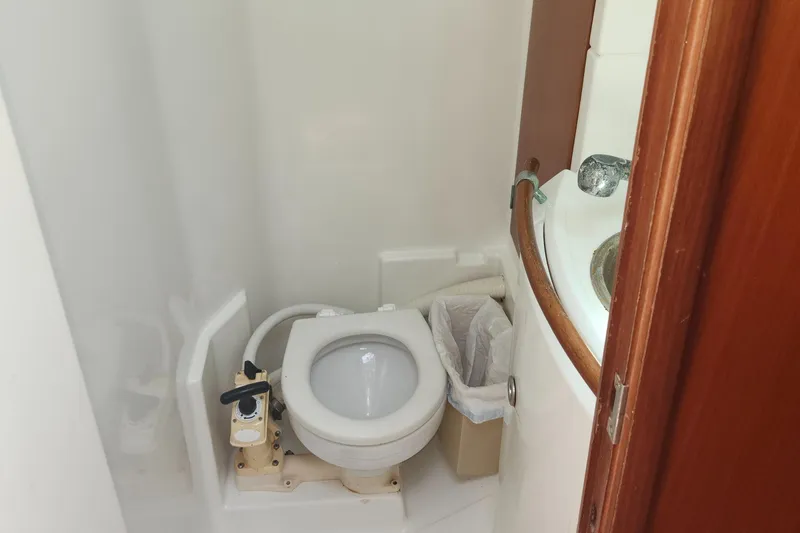Slide: The Image of Compact marine toilet in a 2003 Beneteau 50 yacht bathroom. - 36