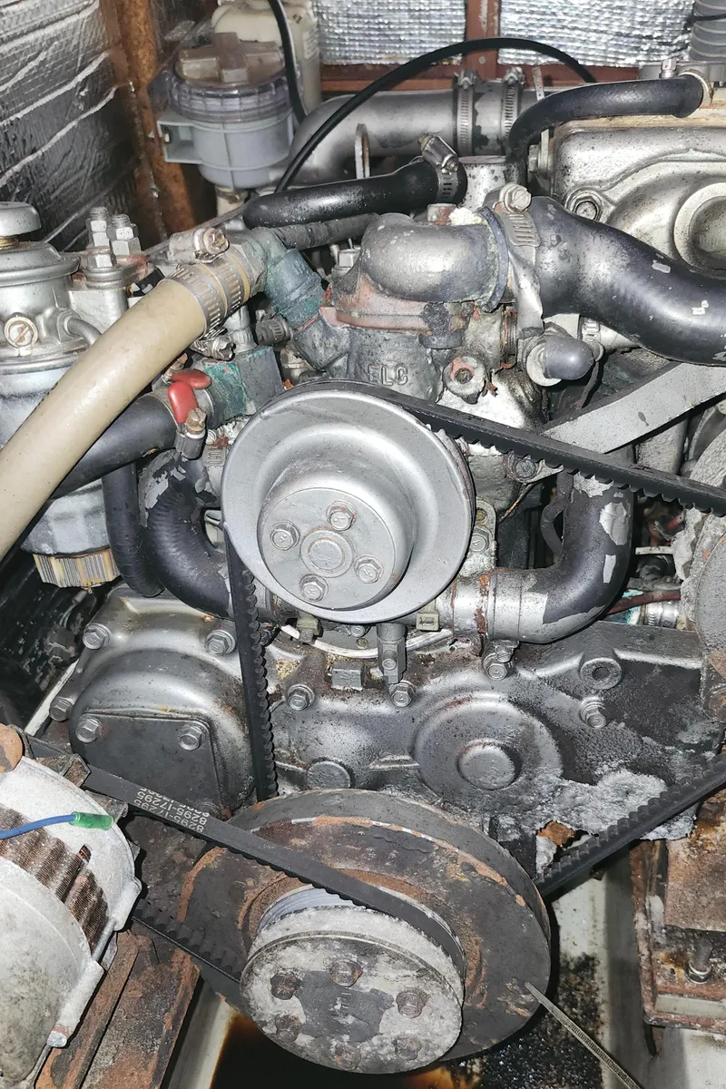 Slide: The Image of Engine of a 2003 Beneteau 50 sailboat, showing belts and components. - 42